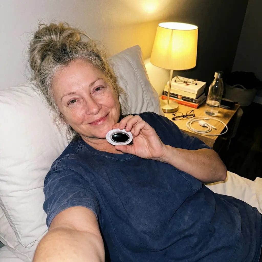 SleepEase Pro customer in bed with the device case
